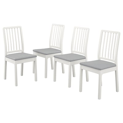 Four white wooden chairs with light grey cushions, arranged in a square. Simple design with vertical slats on back and legs.