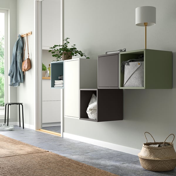 Modern hall featuring multi-color EKET wall cabinets in white, grey, and green, combining open and closed storage for versatile use.