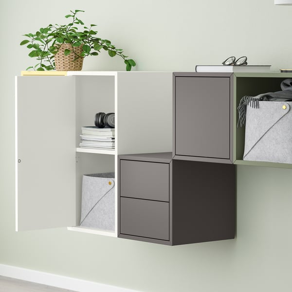Modern wall-mounted storage with open and closed compartments. A functional blend of shelves and grey cabinets, with a potted plant adding greenery.