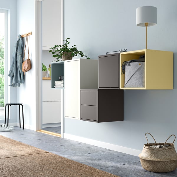 Colourful EKET wall storage with cubes and shelves, lamp, and basket.