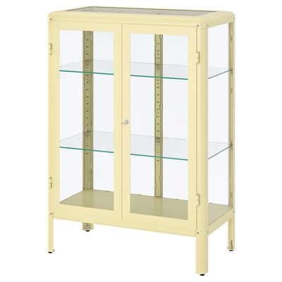 A yellow FABRIKÖR cabinet with glass doors, metal frame, adjustable shelves, and four legs.