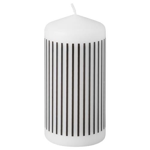 White striped candle. Circular, cylindrical shape. Black vertical stripes. Made of plant and paraffin wax.
