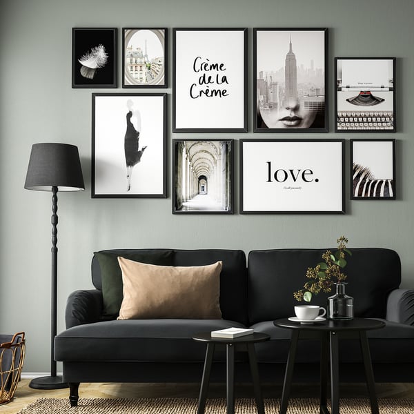 Modern living room with FISKBO wall art, grey sofa, and lamp.