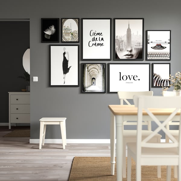 Black & white gallery wall with FISKBO frames complements modern decor, enhances dining space aesthetic.