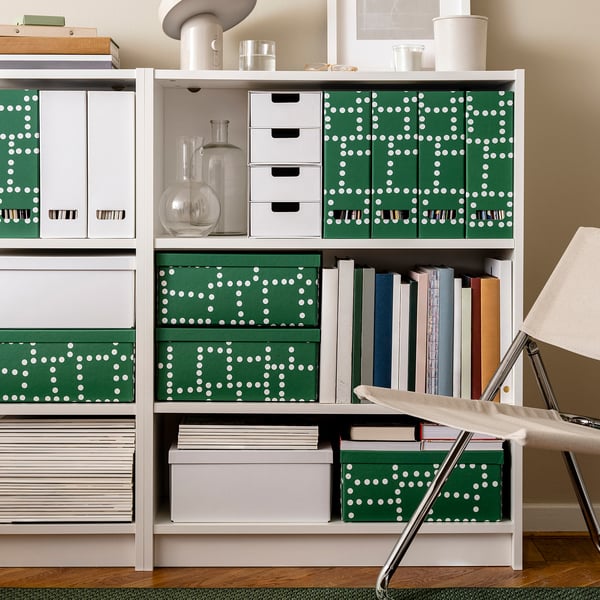 Green and white polka dot storage boxes on shelves, varied sizes, sturdy design, paperboard material, fits a4 and letter size items.
