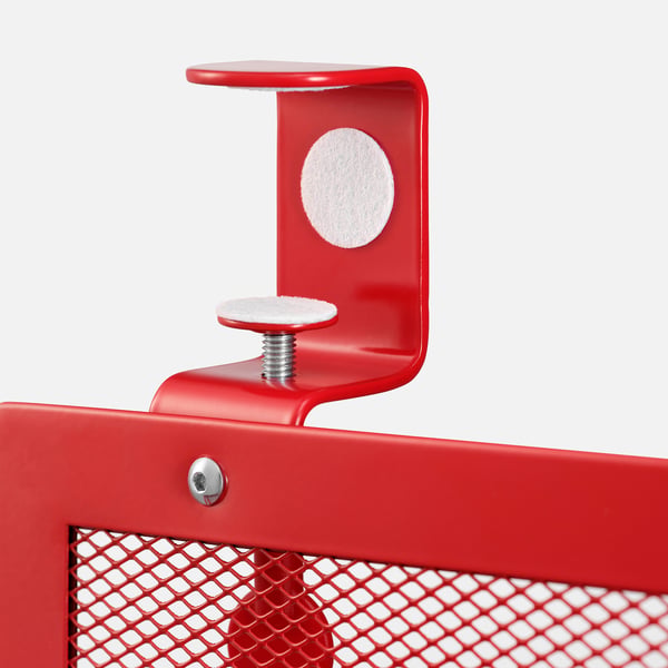 Red metal desk clamp with padded surfaces, securely fastened, showing quality construction and attention to detail.