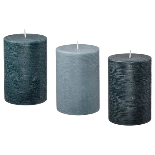 Three cylindrical scented candles of different shades of green, arranged in a row, each with a white wick at the top.