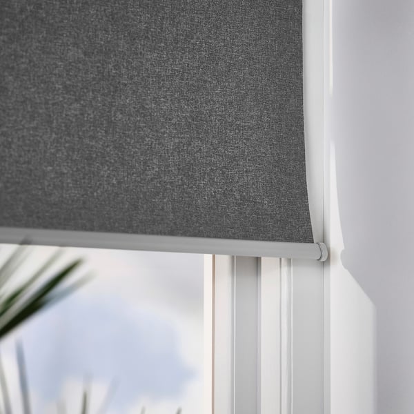 Grey roller blind partially up, revealing slatted white blinds below.