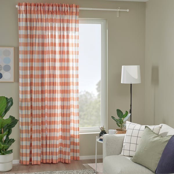 Cosy living room with orange plaid curtains & plants.