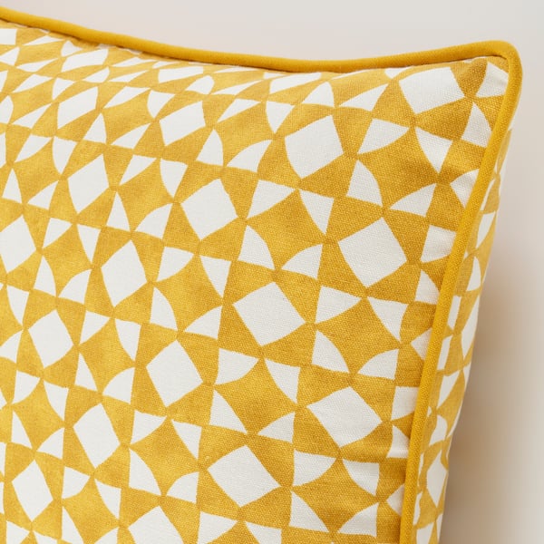 Geometric patterned yellow and white cushion cover with neat piping, showcasing high-quality cotton material and detailed design.