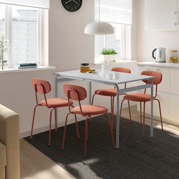Modern dining setup with GRÅSALA table and orange chairs, perfect for daily use.