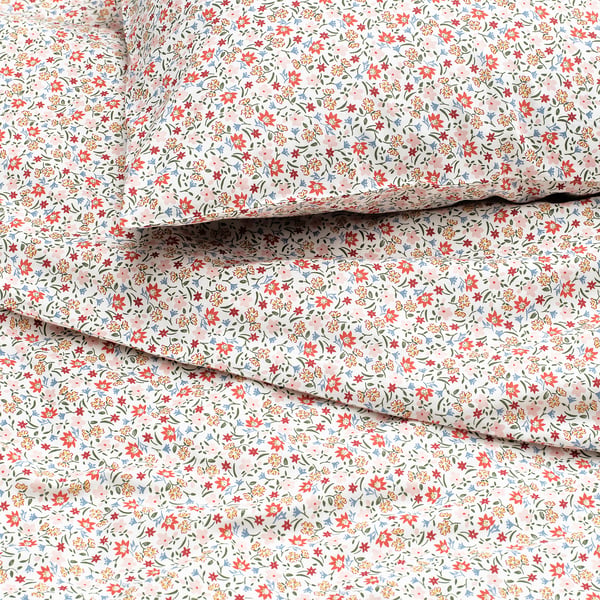 Floral duvet set, folded neatly, showcasing vibrant, tiny flowers on soft, breathable cotton-viscose fabric.