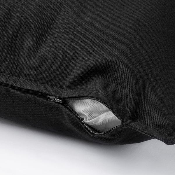 Black cushion cover with visible zip, showcasing easy removal feature.