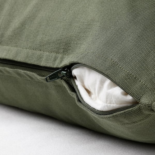 Green cushion cover with hidden zip, easy to remove.