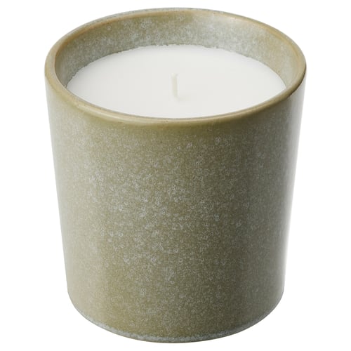 HEDERSAM: green ceramic candle with white wax, cylindrical shape, speckled glaze pattern.