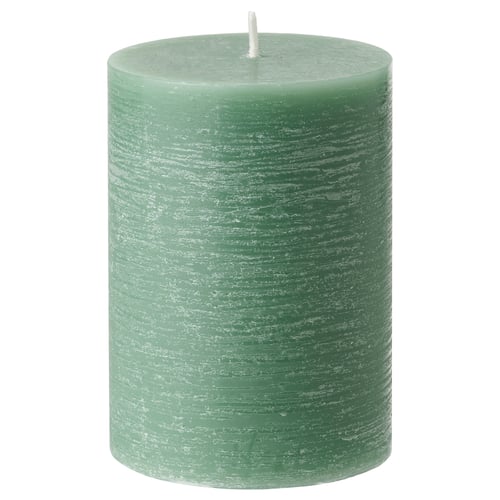 Green, cylindrical scented candle with a white wick, made from plant-based wax.