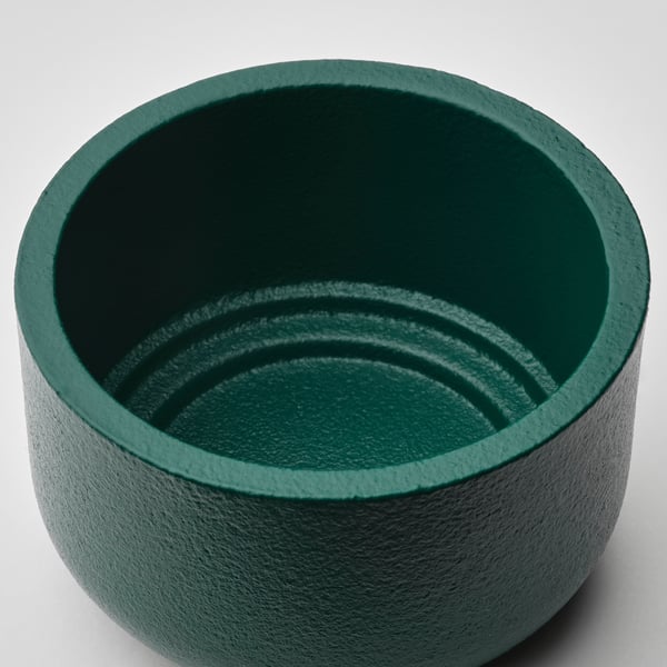 Green textured metal candle holder, smooth and durable, with a modern scandinavian design.