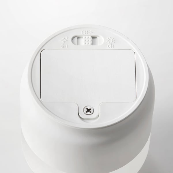 A top view of a sleek white led candle with timer controls.