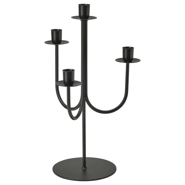 Black 4-arm candelabra, sleek and modern, stands on round base, holds candles at varying heights, made of steel.
