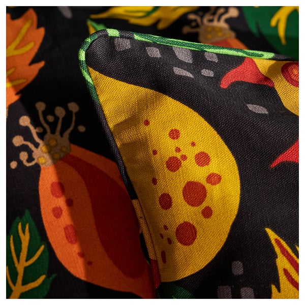 Bright yellow and red rosehip pillow, bordered by green on dark black cotton with floral designs. High-quality stitching and vivid print detail.
