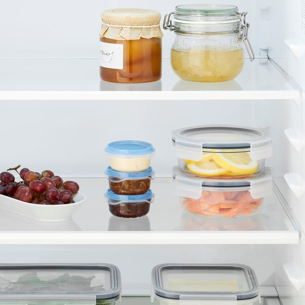 Refrigerator with IKEA 365+ containers: grapes, cheese, jam, lemon, ham, butter.