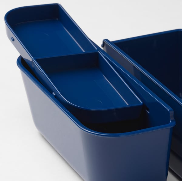 Blue plastic food containers with removable inserts, one with lid, stacked neatly.