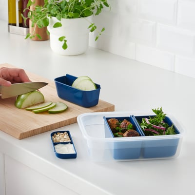 Preparing meal with sliced apple, organised IKEA 365+ container.