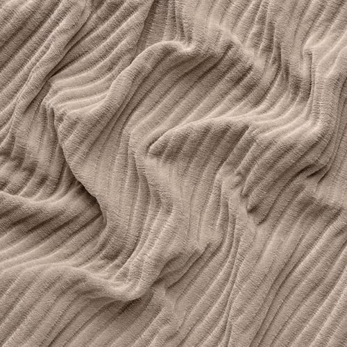 Close-up of textured, thick, soft cushioned fabric, with subtle light reflection.