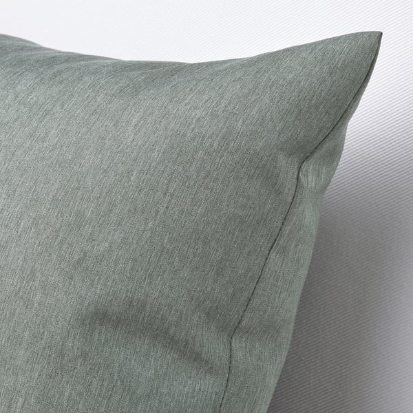 Soft, plush, green cushion close-up, showcasing high-quality texture and stitching.