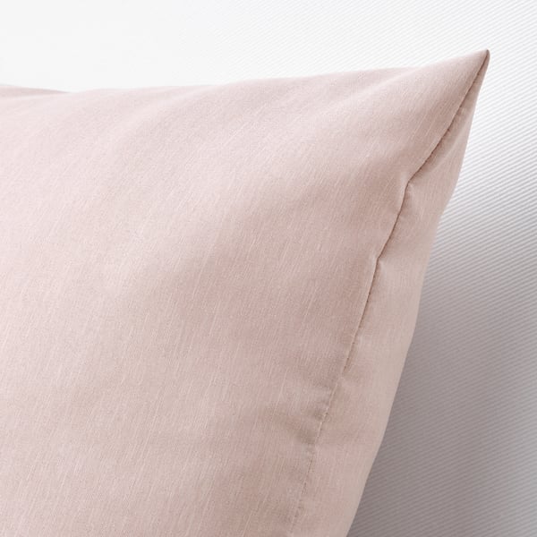 Close-up of soft pink cushion with smooth texture, showcasing quality and comfort.