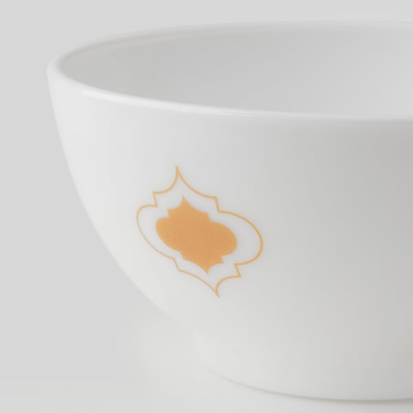 A white bowl with a golden decorative pattern, exemplifying high-quality craftsmanship and elegance.