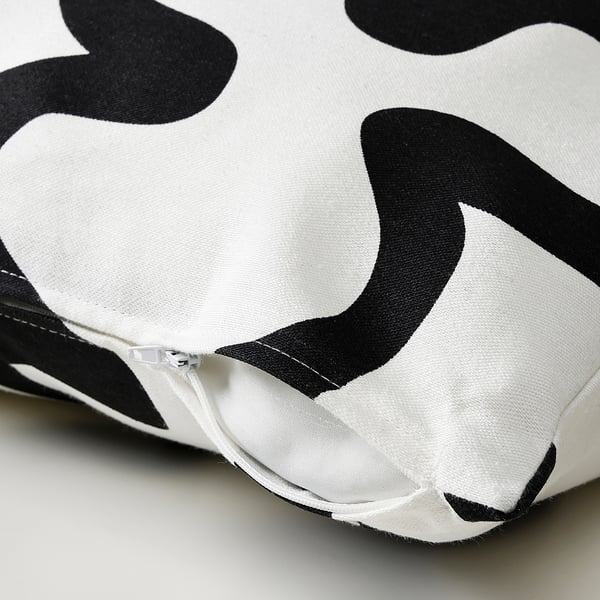 Zippered cushion cover with bold black-white pattern.