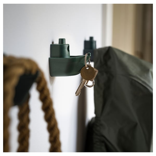 Green wall hook with keys; modern, recycled material, boat-shaped design.