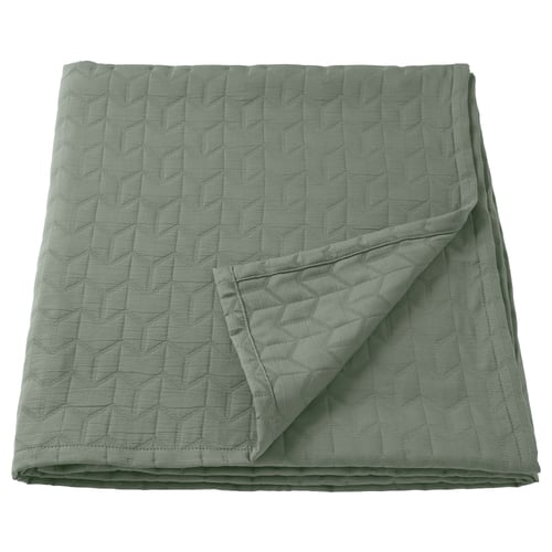 Green quilted bedspread, smooth texture, recycled polyester.