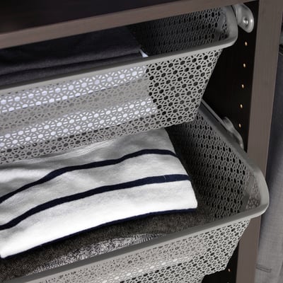 A metal wardrobe basket holding folded clothes, enhancing air circulation and organisation.