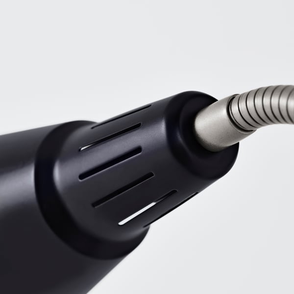 Black adjustable work lamp close-up, showcasing robust construction with a dark, textured grip, and flexible neck for precise lighting adjustments.