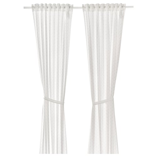 White cotton curtains with tiny dots and tiebacks.