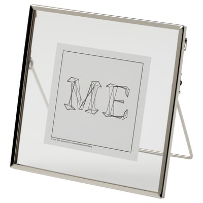 A LERBODA frame, silver, standing with a modern design displaying the letters me.