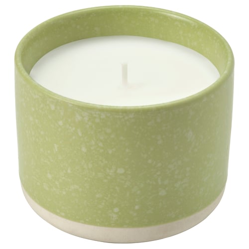 Green ceramic candle with white wax, cylindrical shape, speckled design, zoo.