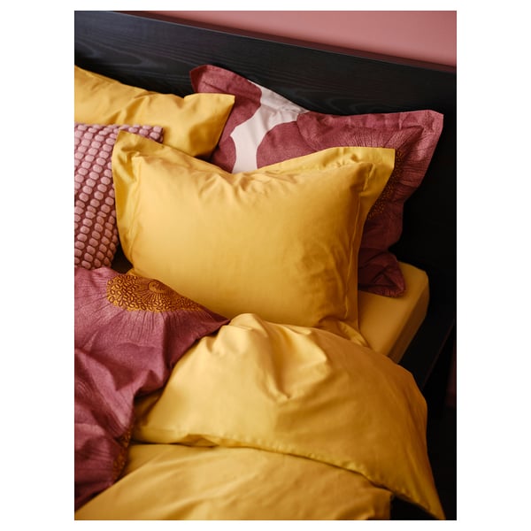 A golden yellow LUKTJASMIN duvet set with smooth sateen weave, cotton, and lyocell, featuring button closure and envelope pillowcase.