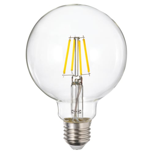 Light bulb with yellow filaments, spherical glass cover, silver base, ikea brand.