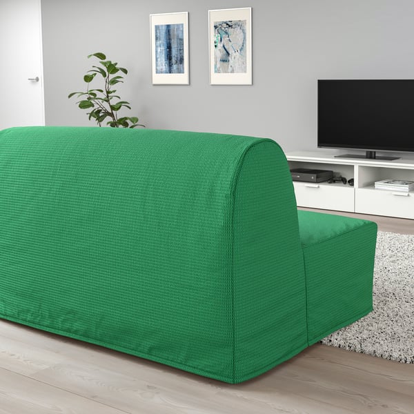 Green LYCKSELE LÖVÅS sofa-bed in living room with tv, art, plant.