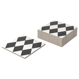 Two stacks of square, black-and-white harlequin pattern coasters; eight in total, made of feldspar porcelain.