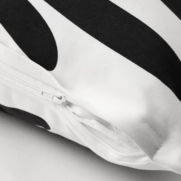 Hidden zip on off-white/black leaf-patterned cotton cushion cover.