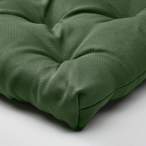 Green chair pad, thick and cushioned, made of recycled material, folds neatly.