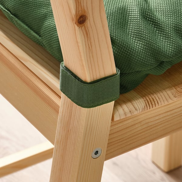Green chair pad on light wooden chair, securely fastened.