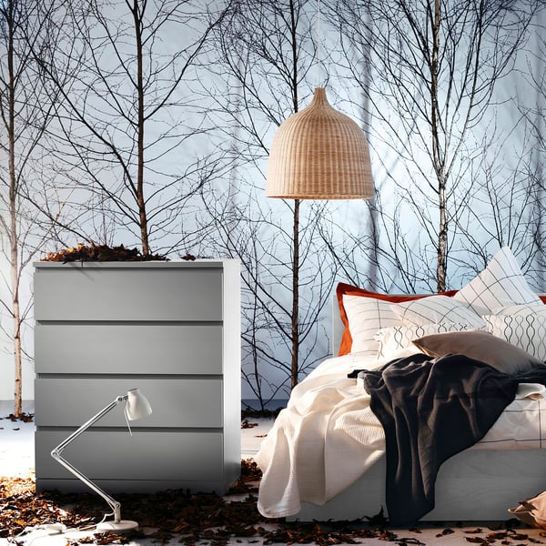Modern grey bedroom set featuring a high headboard bed with multiple drawers and a wicker pendant lamp.