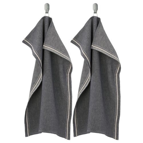 Two dark grey MARIATHERES towels hang side-by-side on hooks, made of cotton and linen blend, featuring a textured design with light grey edges.