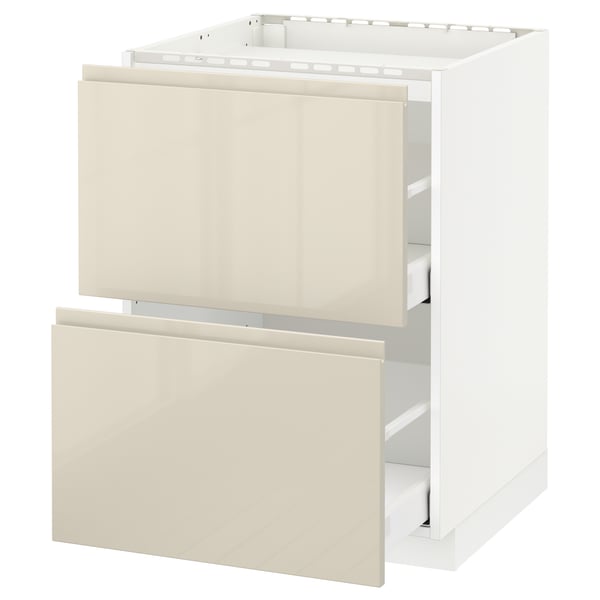 A white METOD kitchen cabinet with high gloss beige drawers and integrated handles.