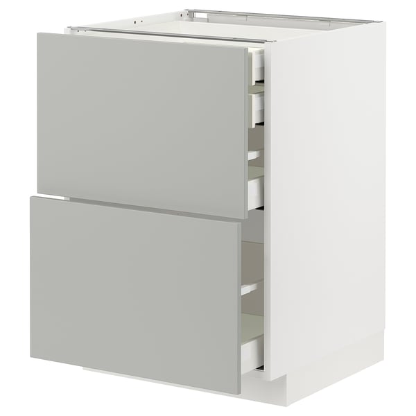 A white METOD kitchen cabinet with light grey drawers, featuring a modern clean design.